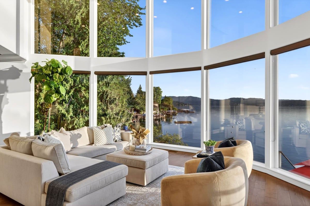 The great room under thirty-foot ceilings, facing the lake